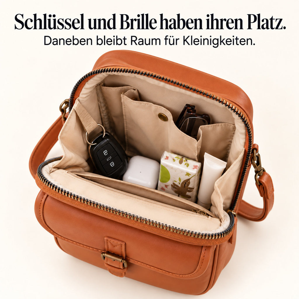 Mavelle mit Brille, Kopfhörer-Etui, Taschentüchern und Schlüssel im Hauptfach – Studiomotiv. Schlüssel und Brille haben ihren Platz. Daneben bleibt Raum für Kleinigkeiten.